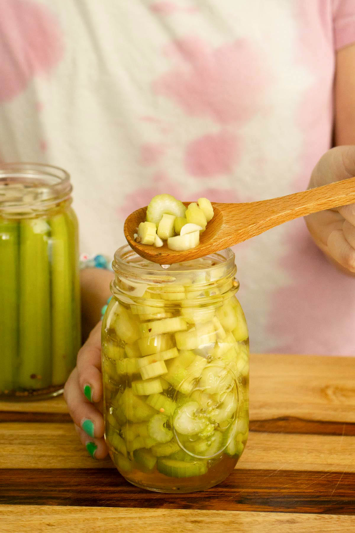 spoon serving up some pickled celery slices