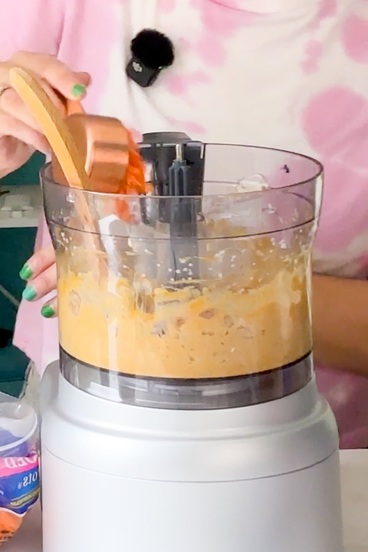 adding shredded carrots to the white bean mixture in the food processor