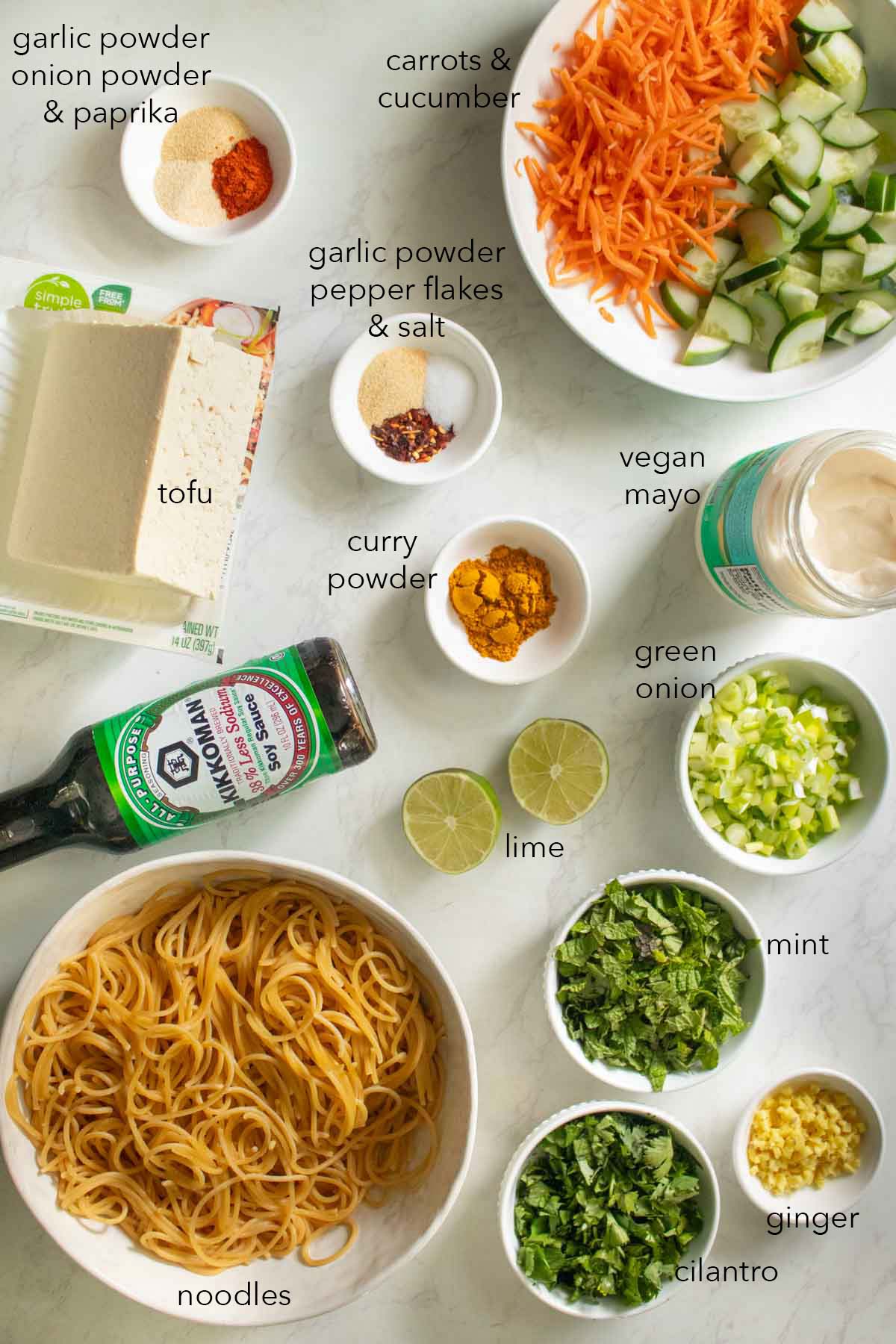 curry noodle salad ingredients on a white table