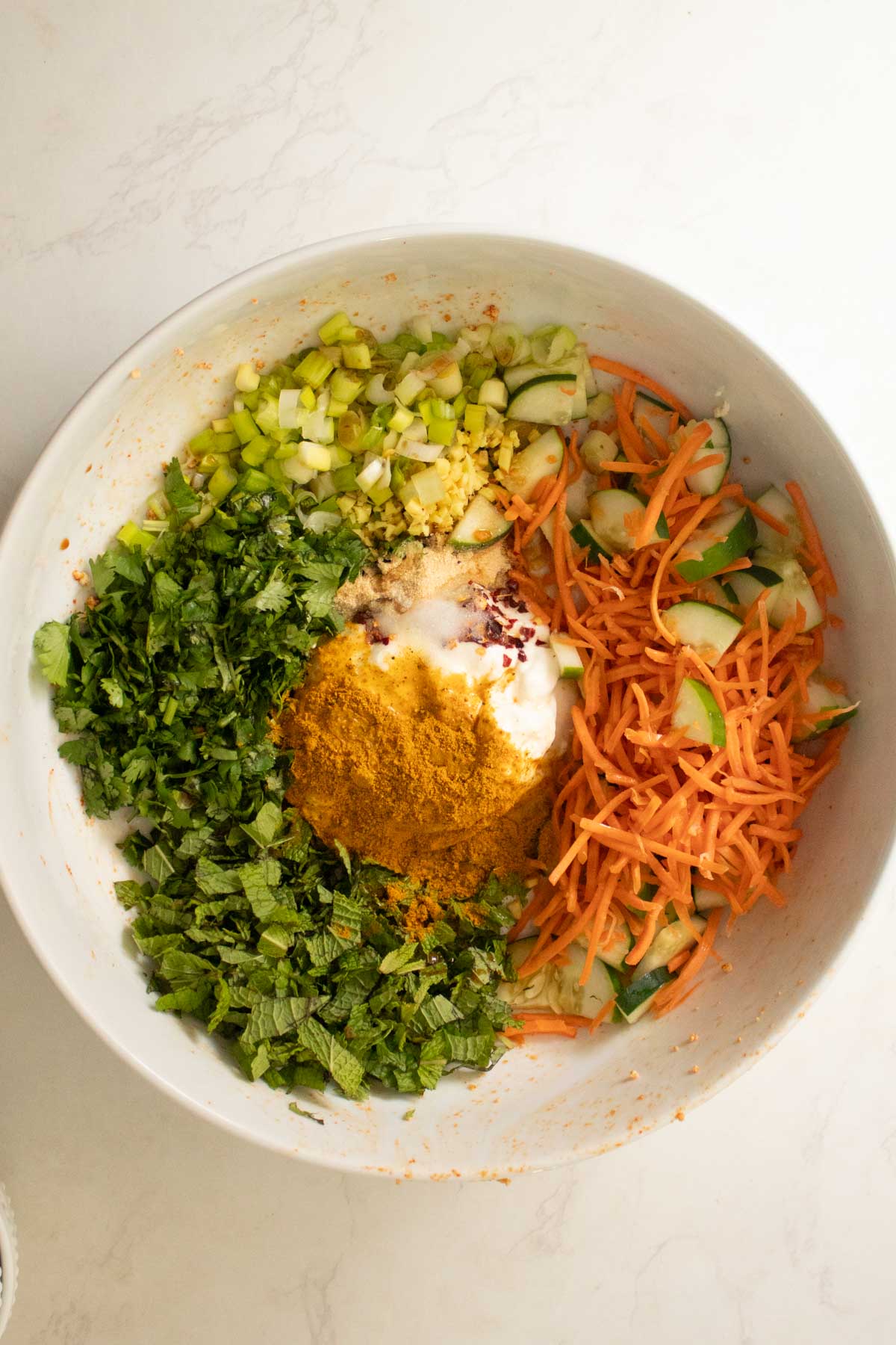 adding no-cook curry sauce ingredients to the bowl