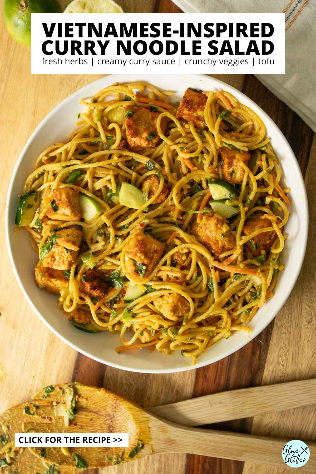 bowl of curry noodle salad on a wooden table, text overlay
