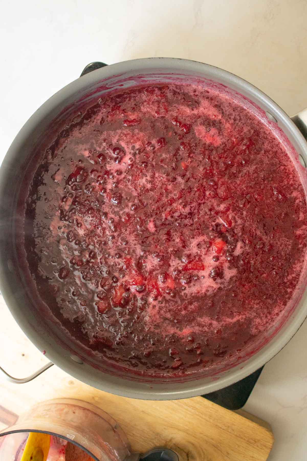plum freezer jam simmering in the pan