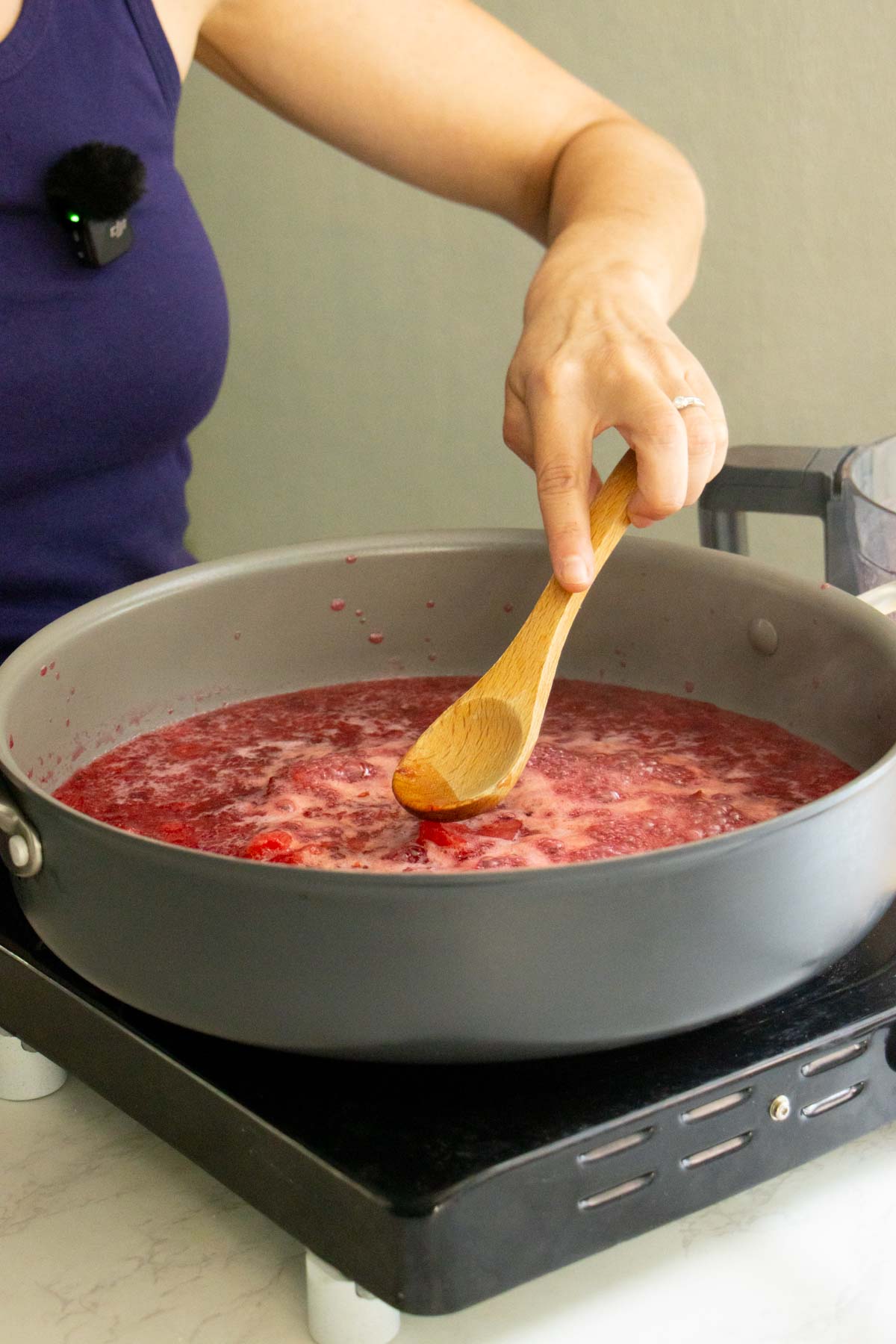 using a spoon to mash large pieces in the pan