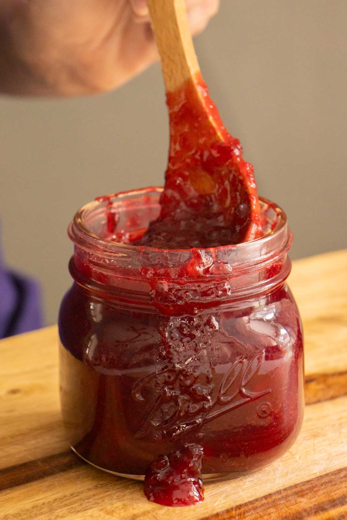 spoon in a jar of plum freezer jam