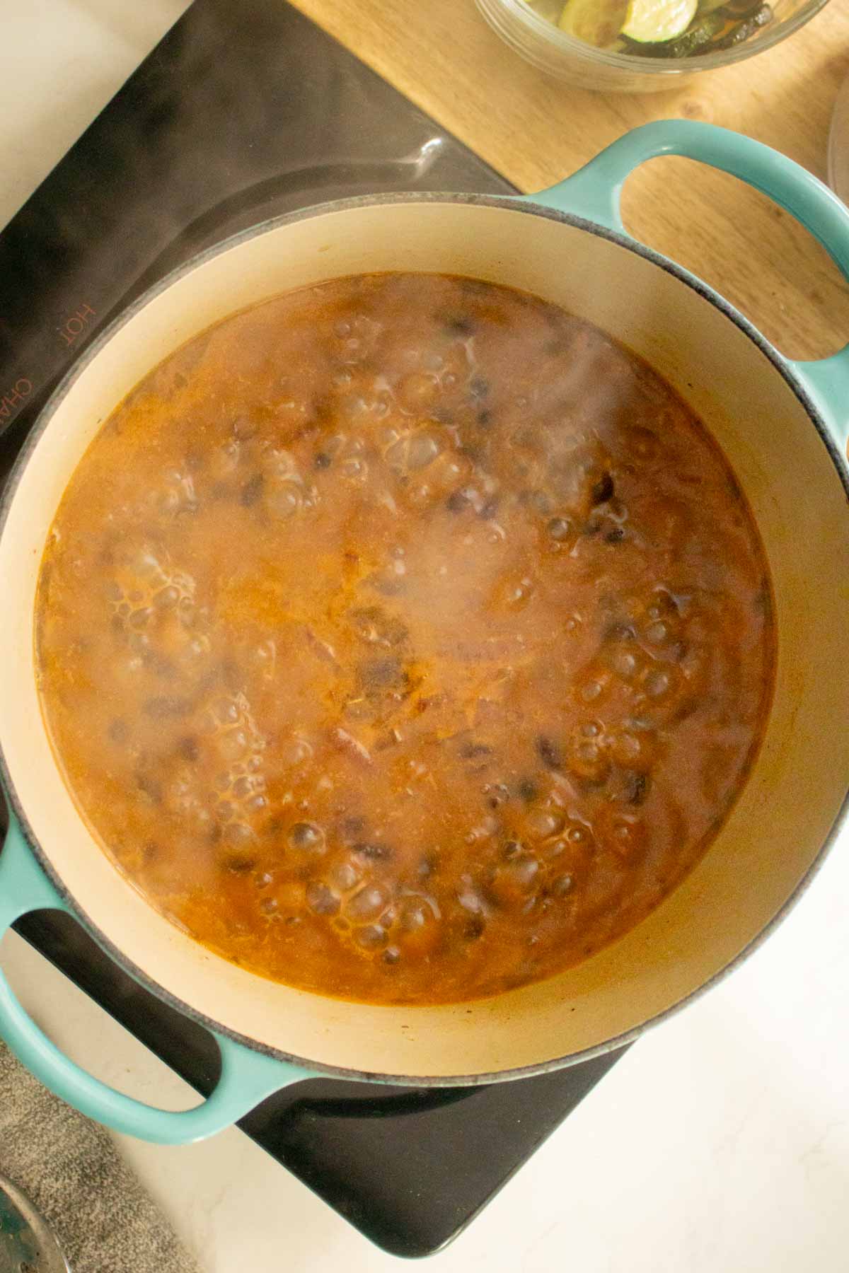 smoky black beans simmering in the pot