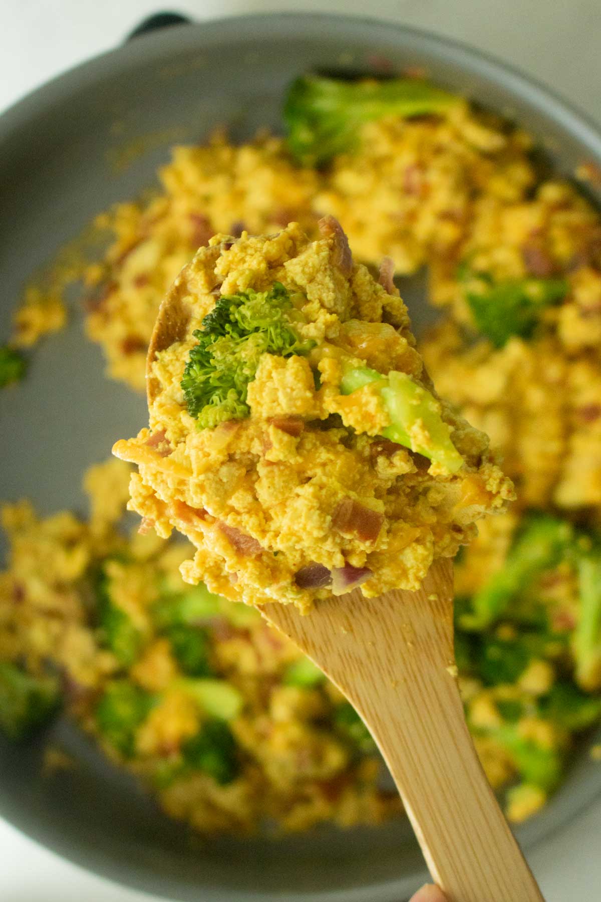 spoon holding a scoop of the tofu scramble