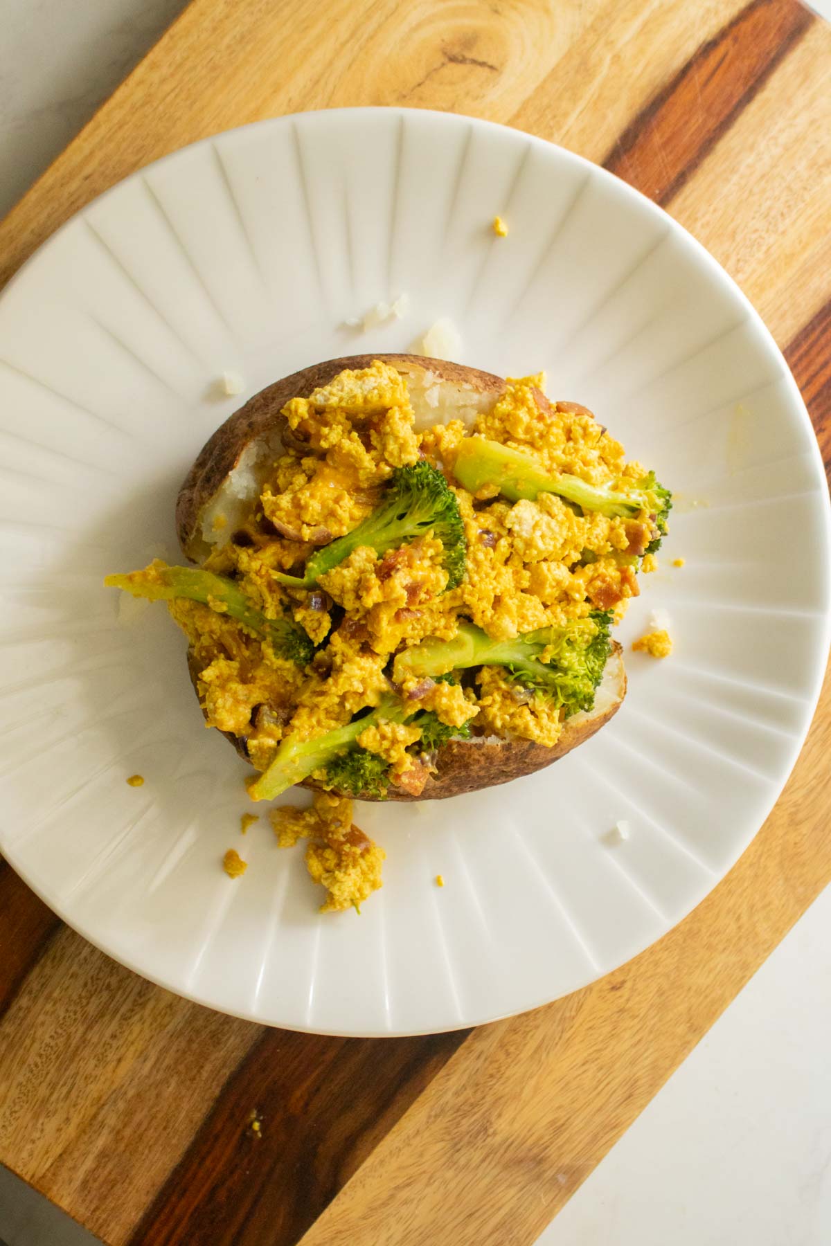 adding tofu scramble to the baked potato