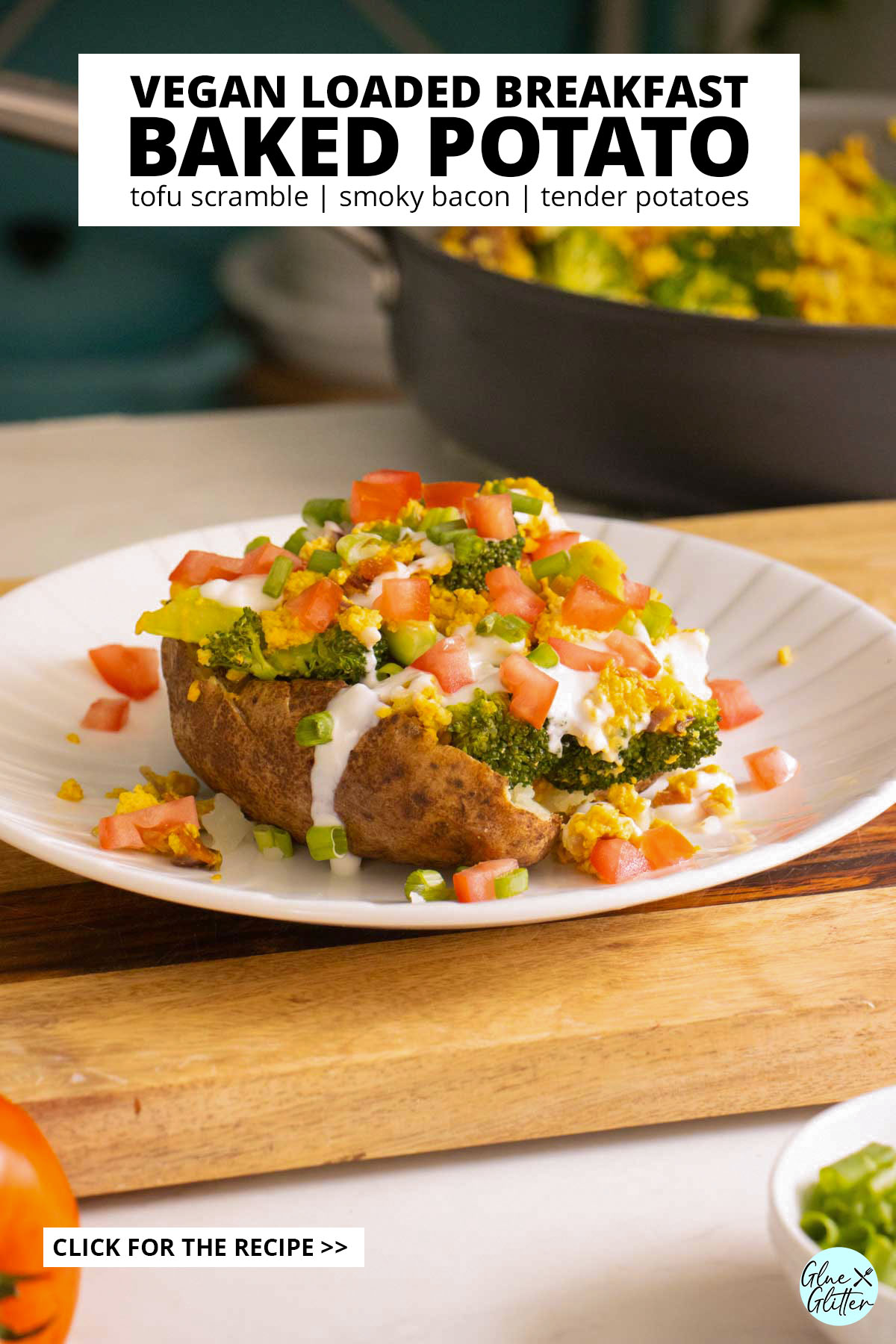 loaded baked breakfast potato on a plate with all the toppings, pan of tofu scrambled the background, text overlay