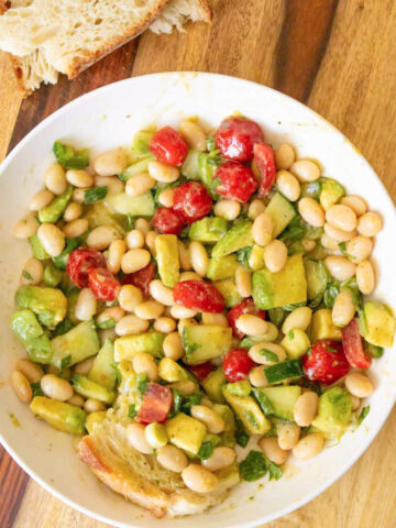 white bean salad on a wooden cutting board
