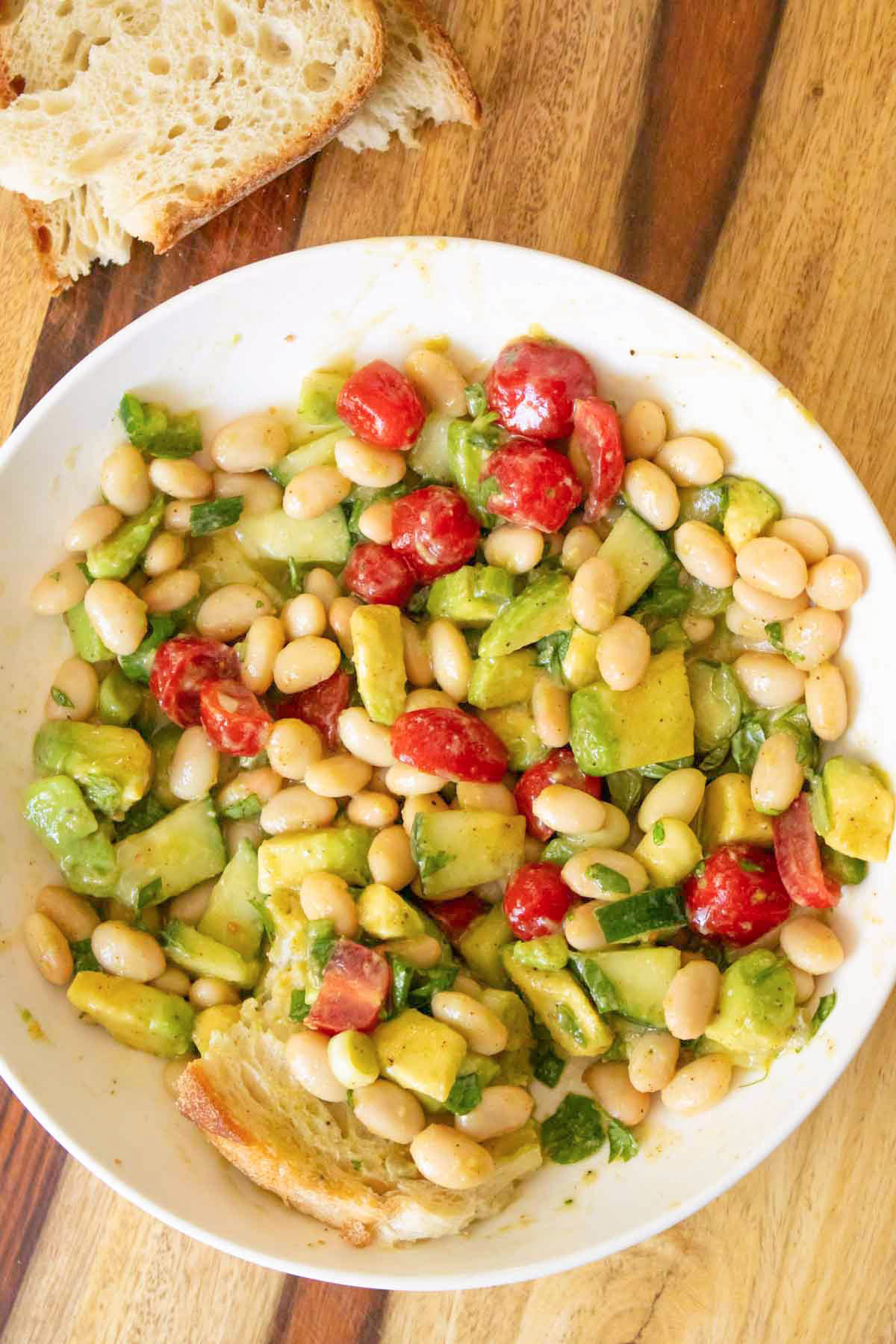 white bean salad on a wooden cutting board