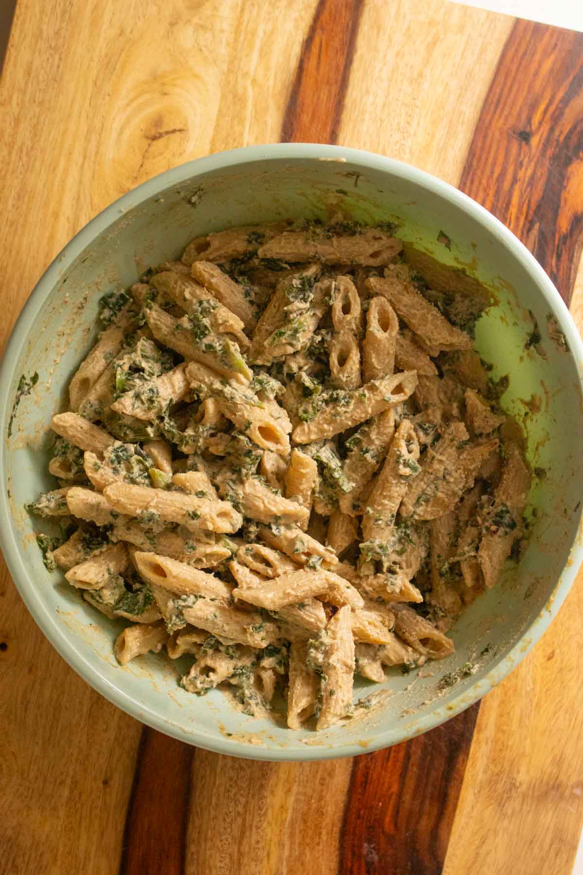 pasta and kale after tossing with white pasta sauce