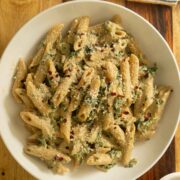 bowl of pasta with white pasta sauce and veggies