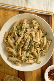 bowl of pasta with white pasta sauce and veggies