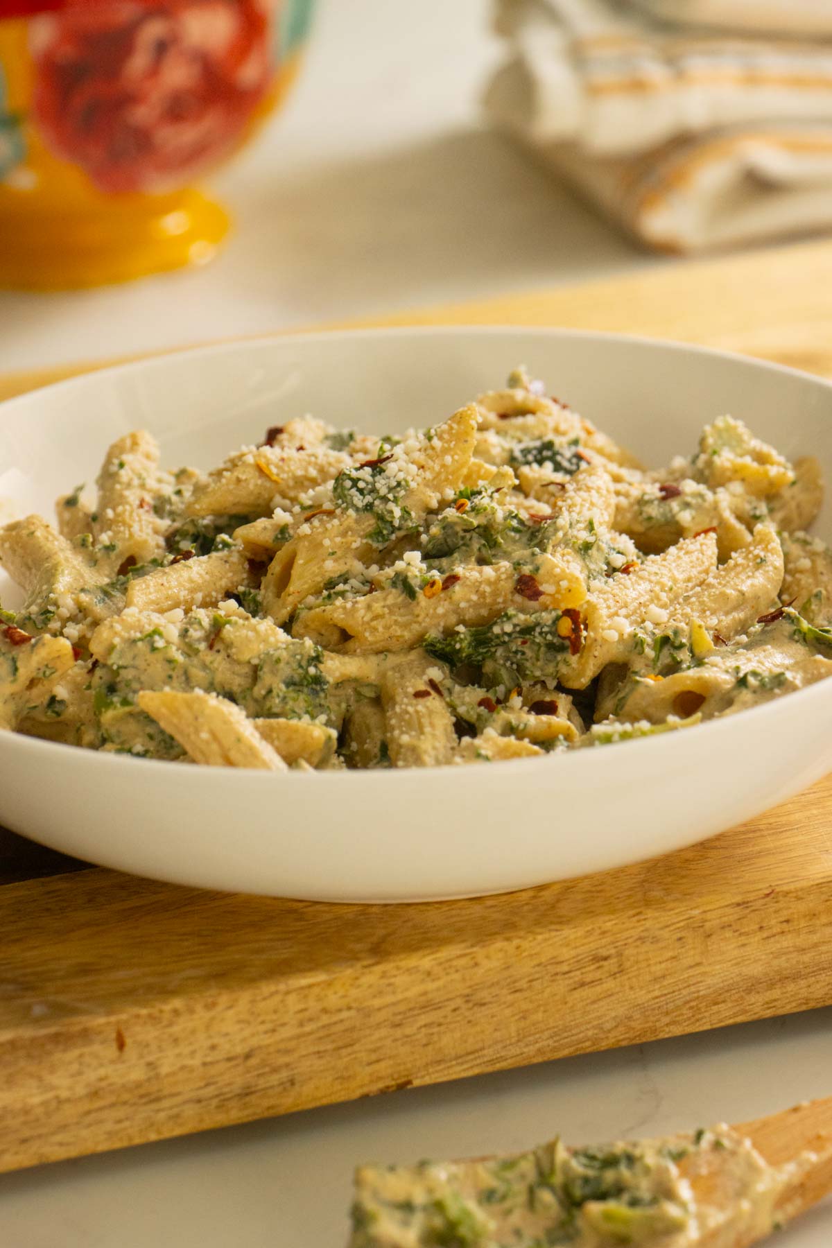bowl of pasta with white pasta sauce and veggies