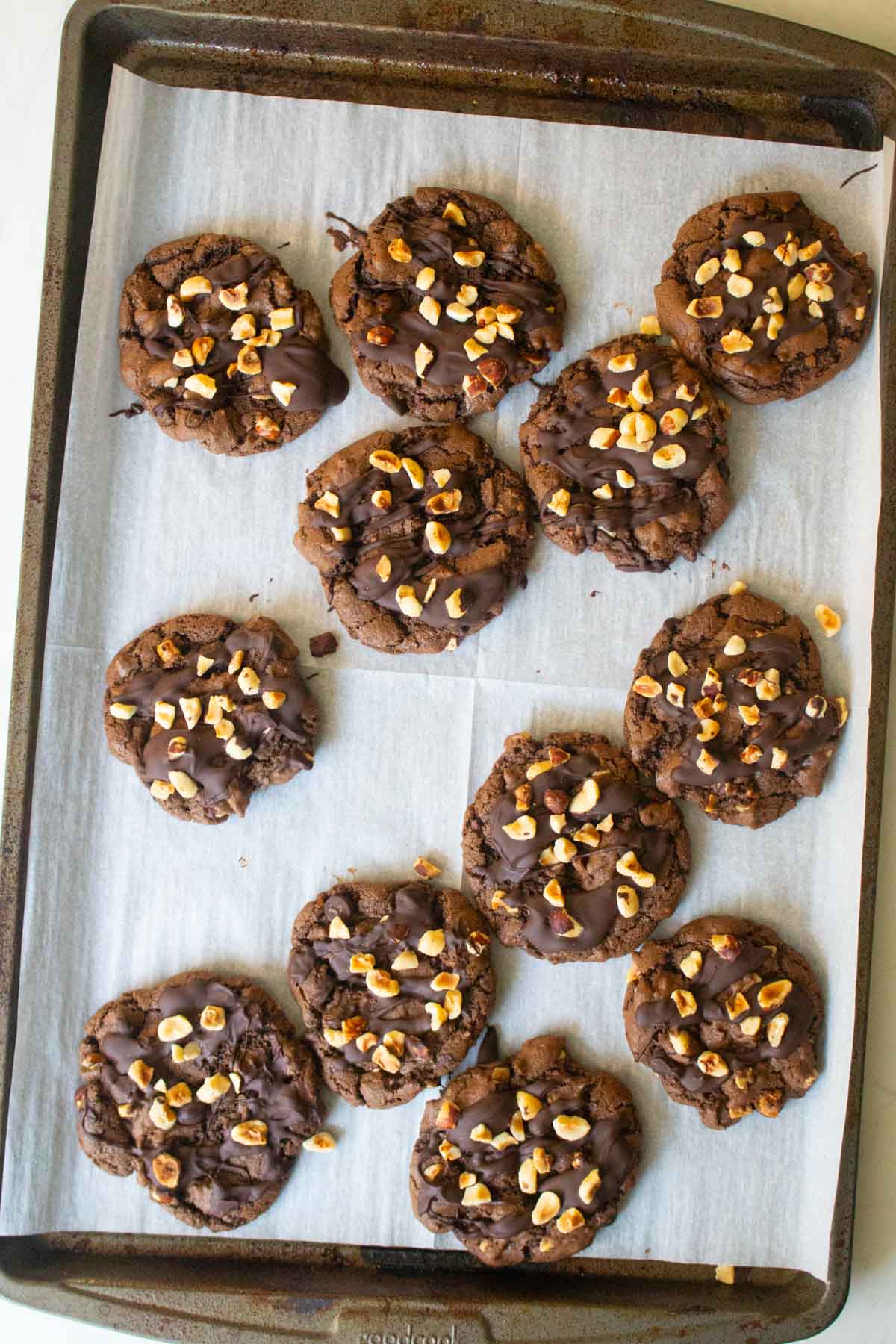 chocolate hazelnut cookies on the baking sheet after topping and cooling