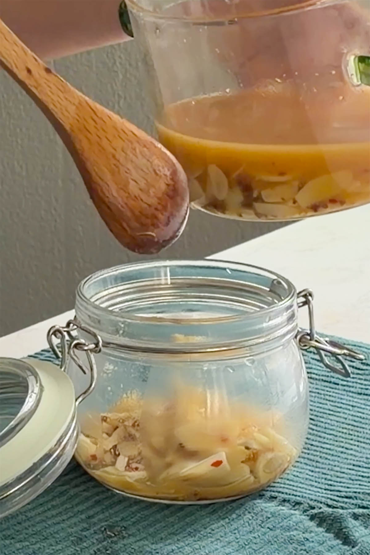 transferring the pickled garlic to the jar