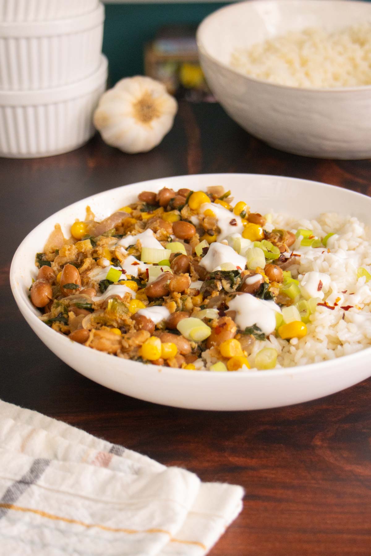 bowl of pinto bean curry on a wooden table