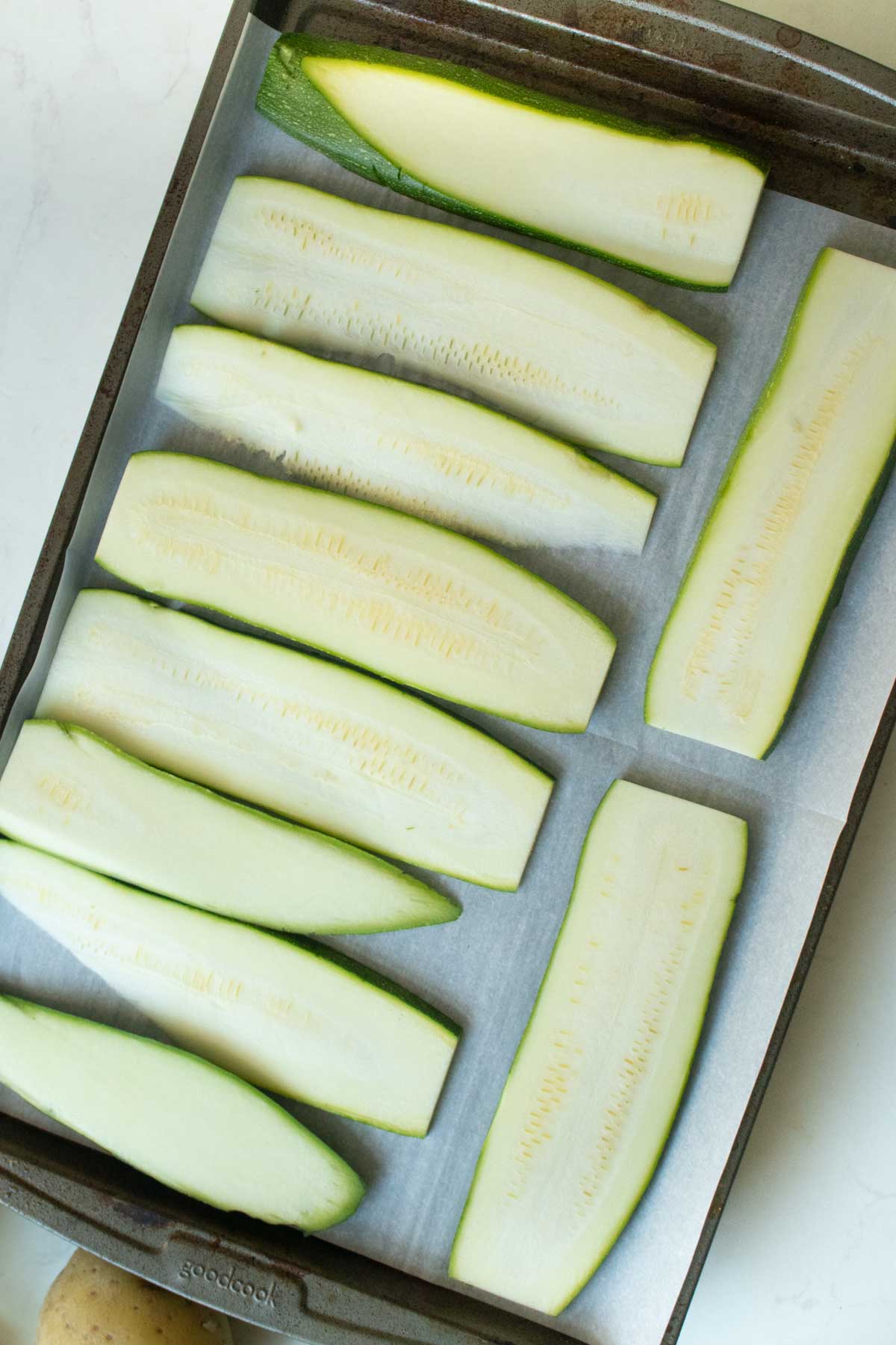 sliced zucchini on the baking sheet before baking