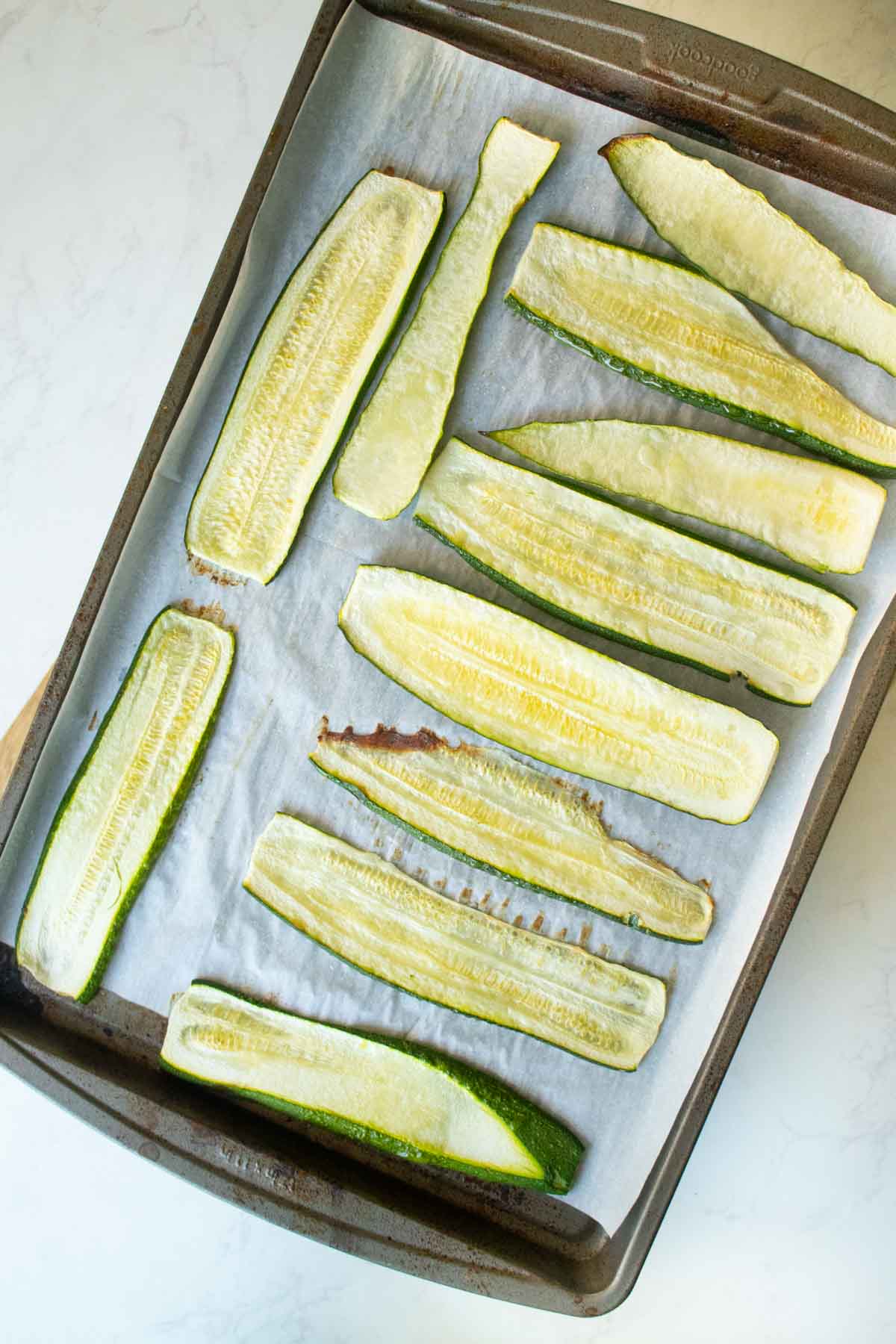 sliced zucchini on the baking sheet after baking