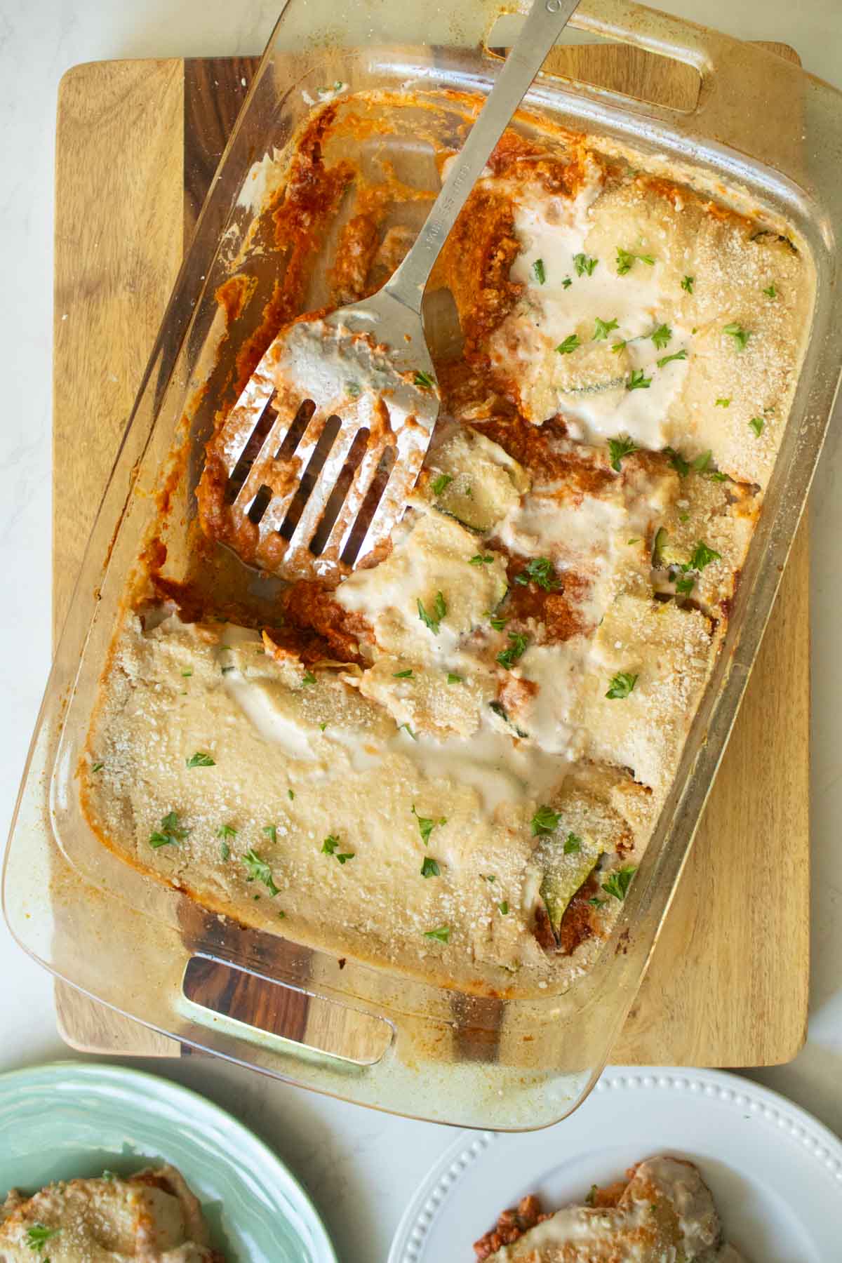 baking pan of zucchini moussaka with a couple of slices removed