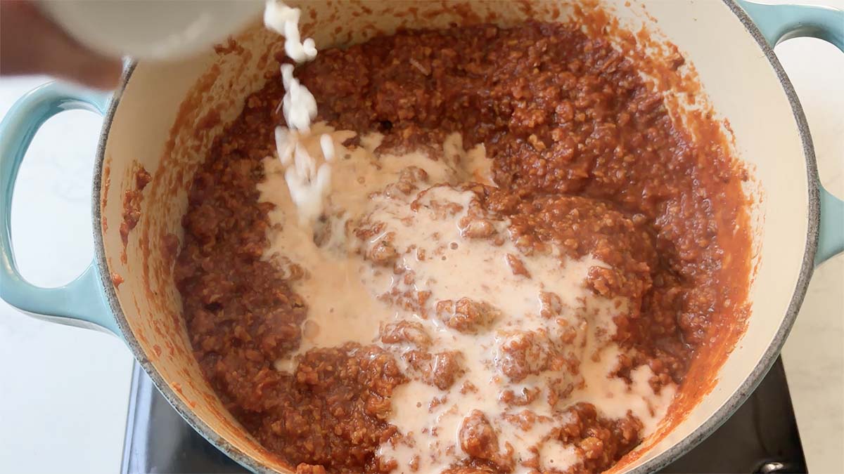 adding the cornstarch slurry to the vegan meat sauce