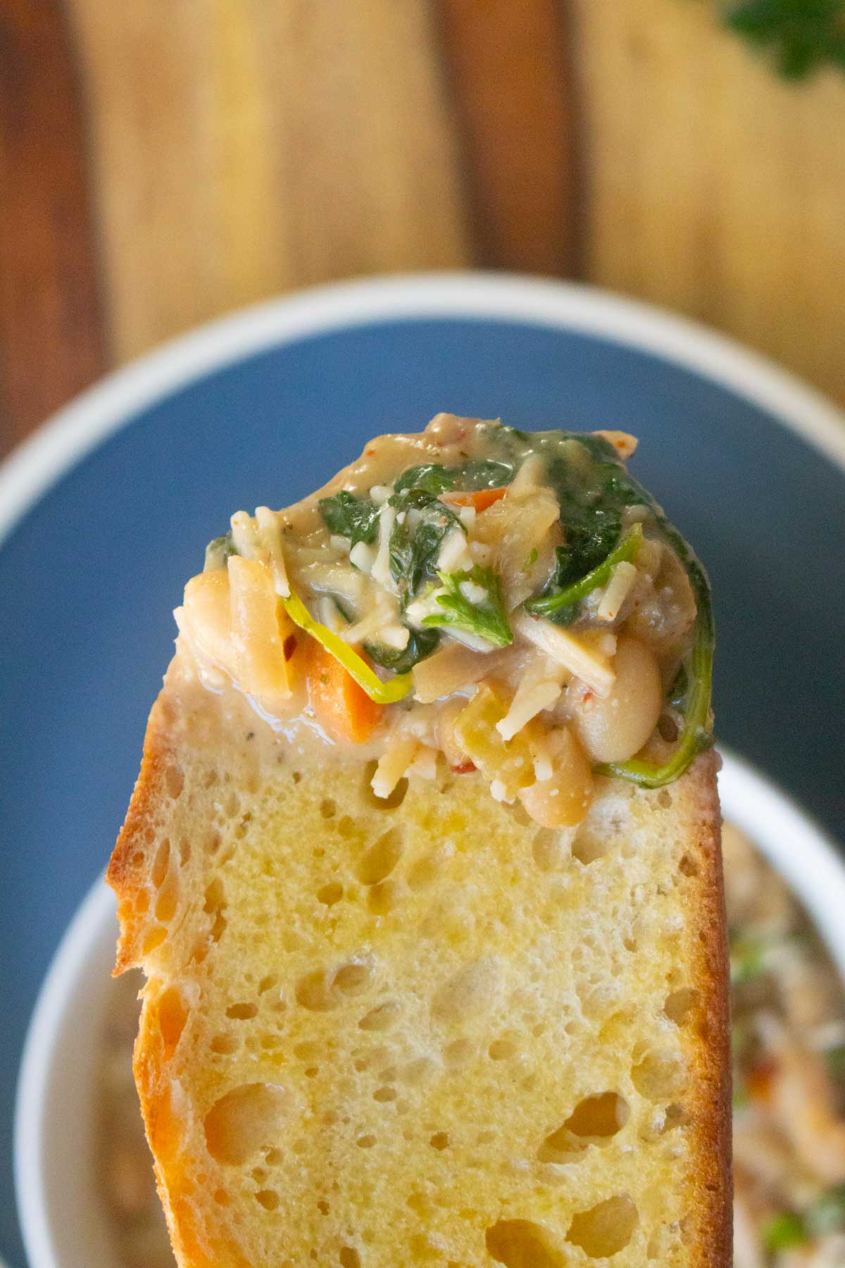 lemon white bean soup scooped up onto a bread slice