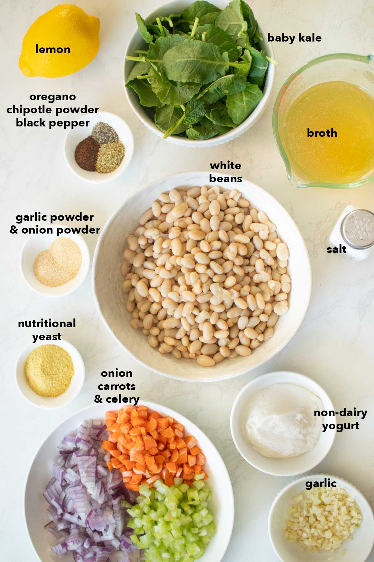 lemon white bean soup ingredients on a white table