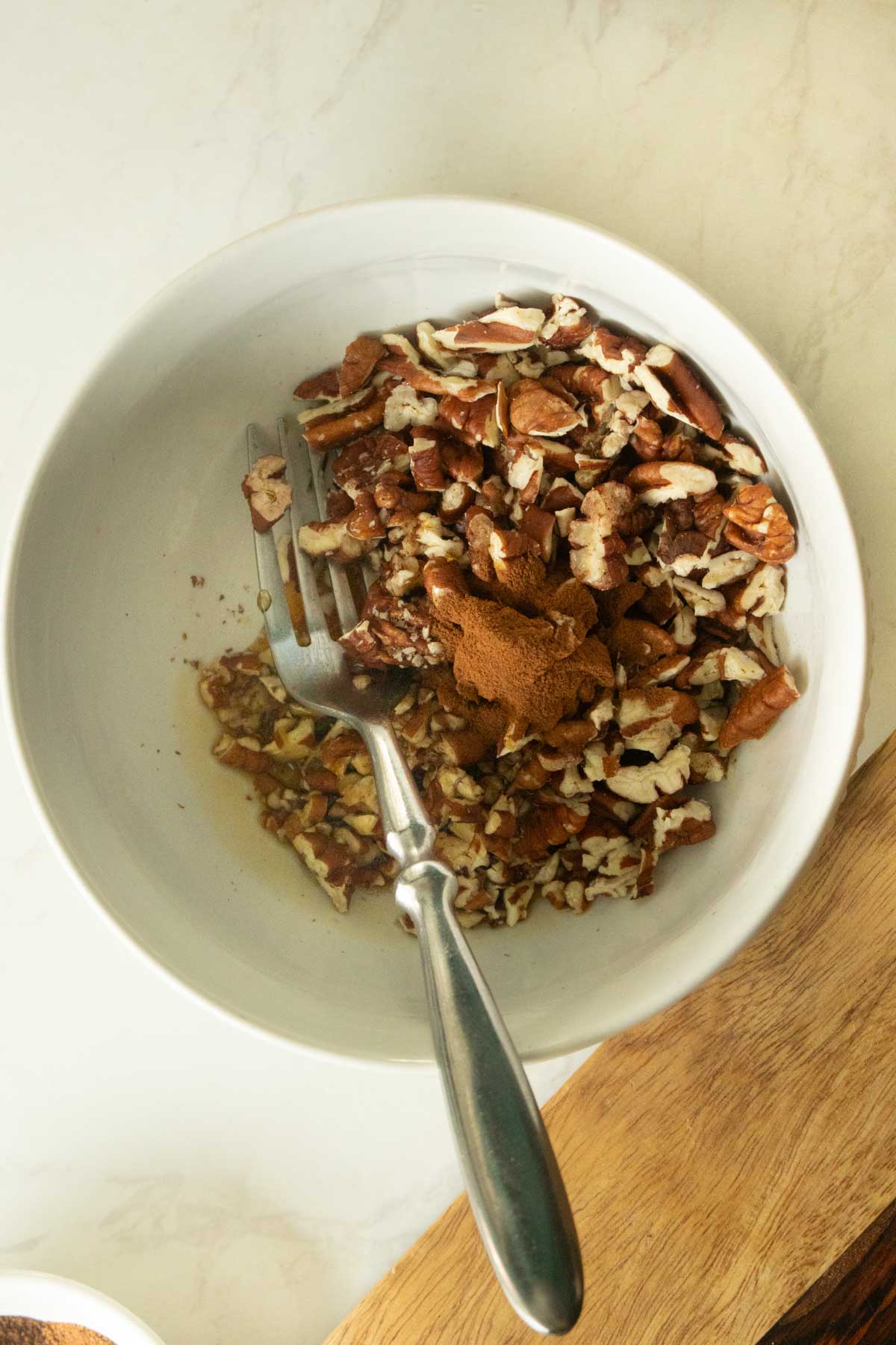 chopped pecans, maple syrup, and cinnamon in a small bowl
