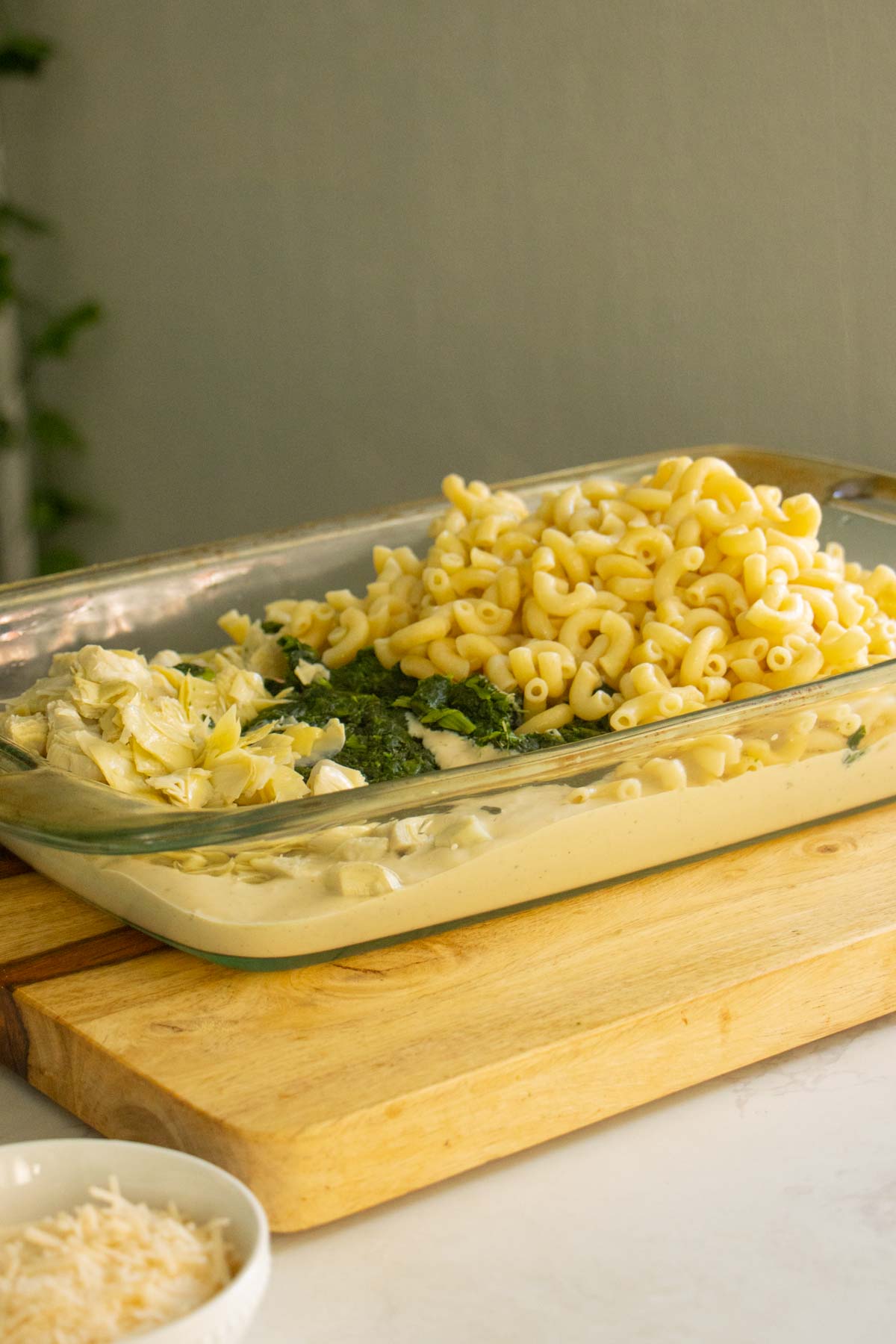 pasta, cream sauce, spinach, and artichokes in the pan before mixing