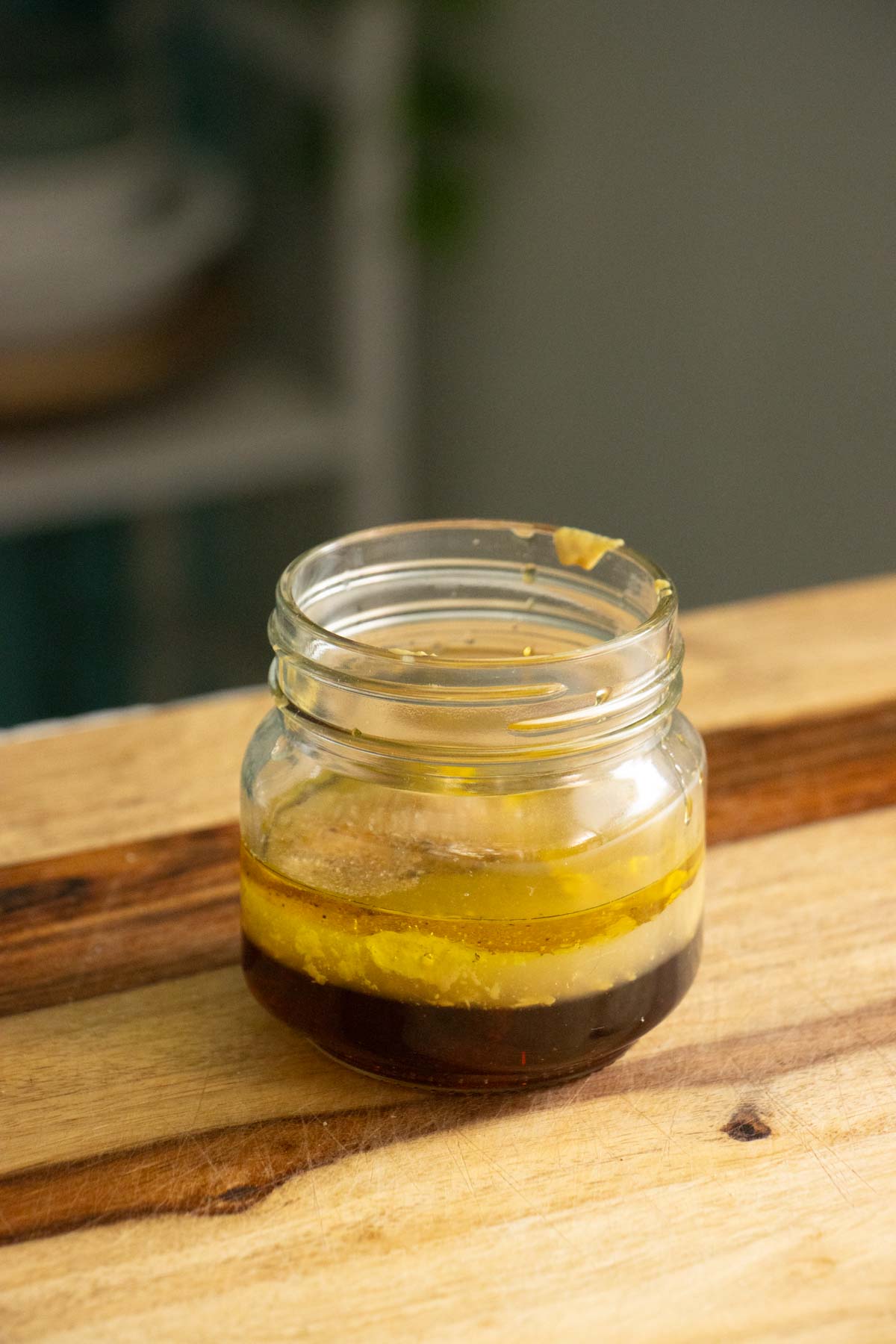 maple mustard dressing ingredients in a jar before mixing