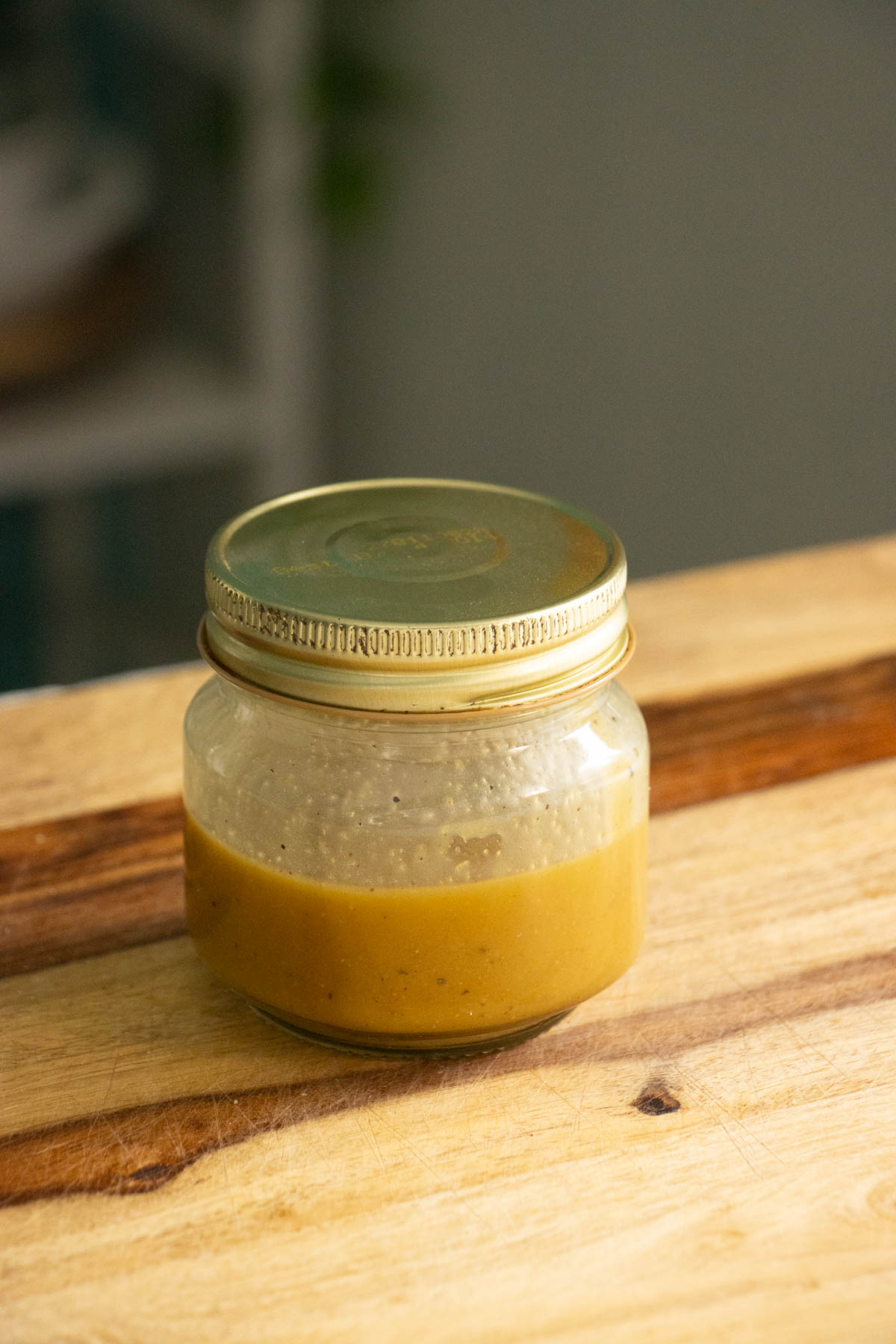 maple mustard dressing ingredients in a jar after mixing
