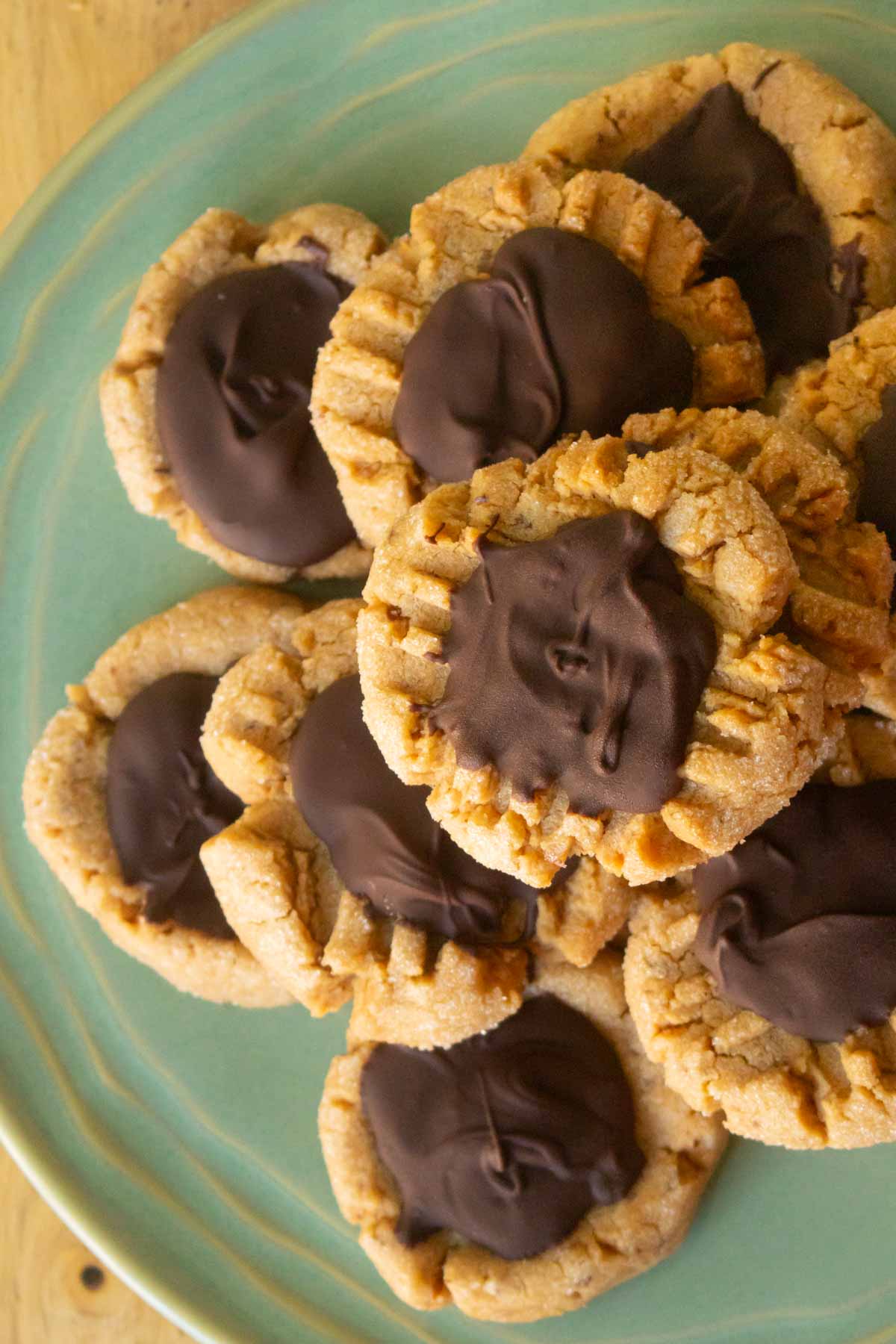 overhead photo of close-up of peanut butter chocolate cookies stacked on a plate