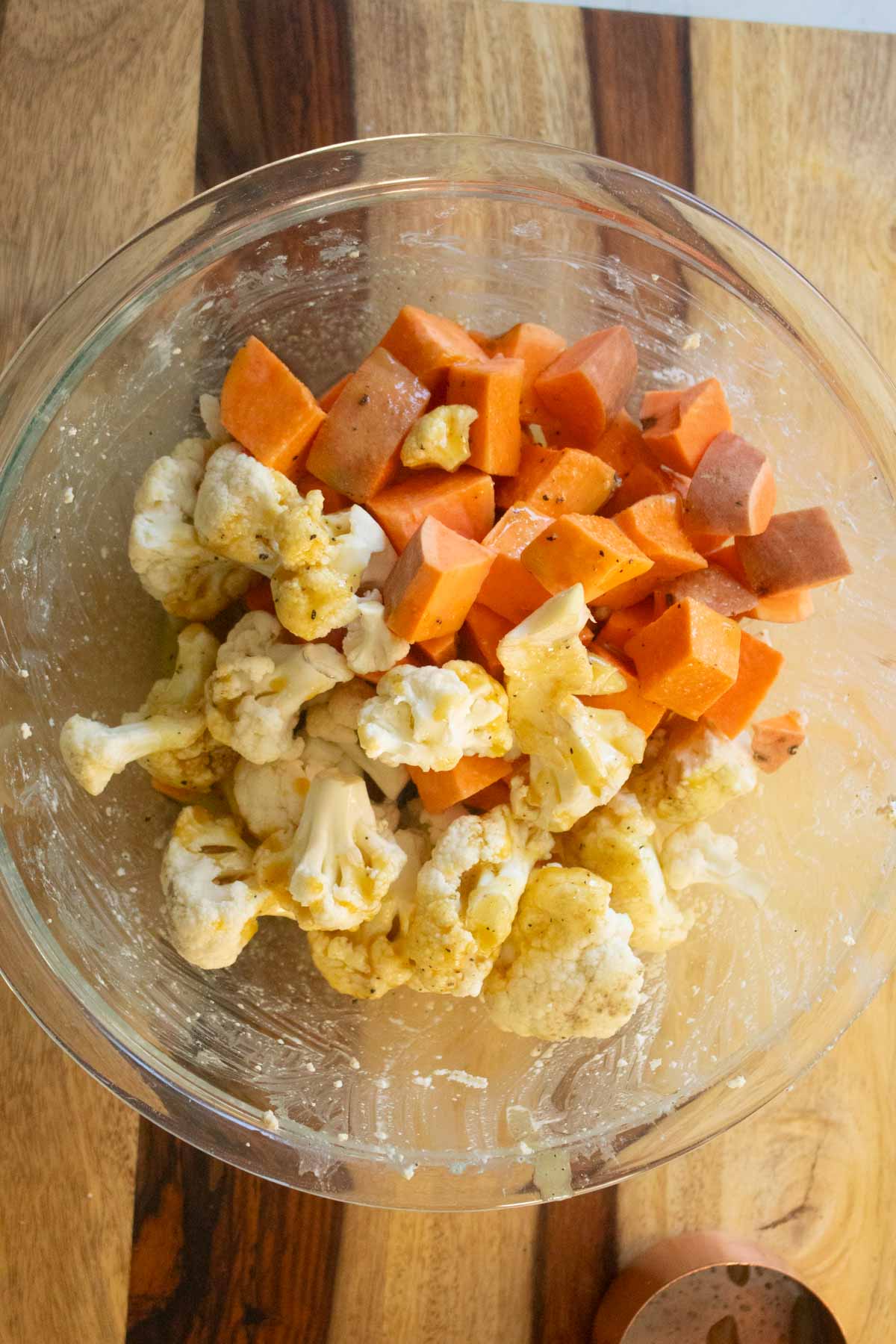 cauliflower and sweet potato in the bowl with the sauce