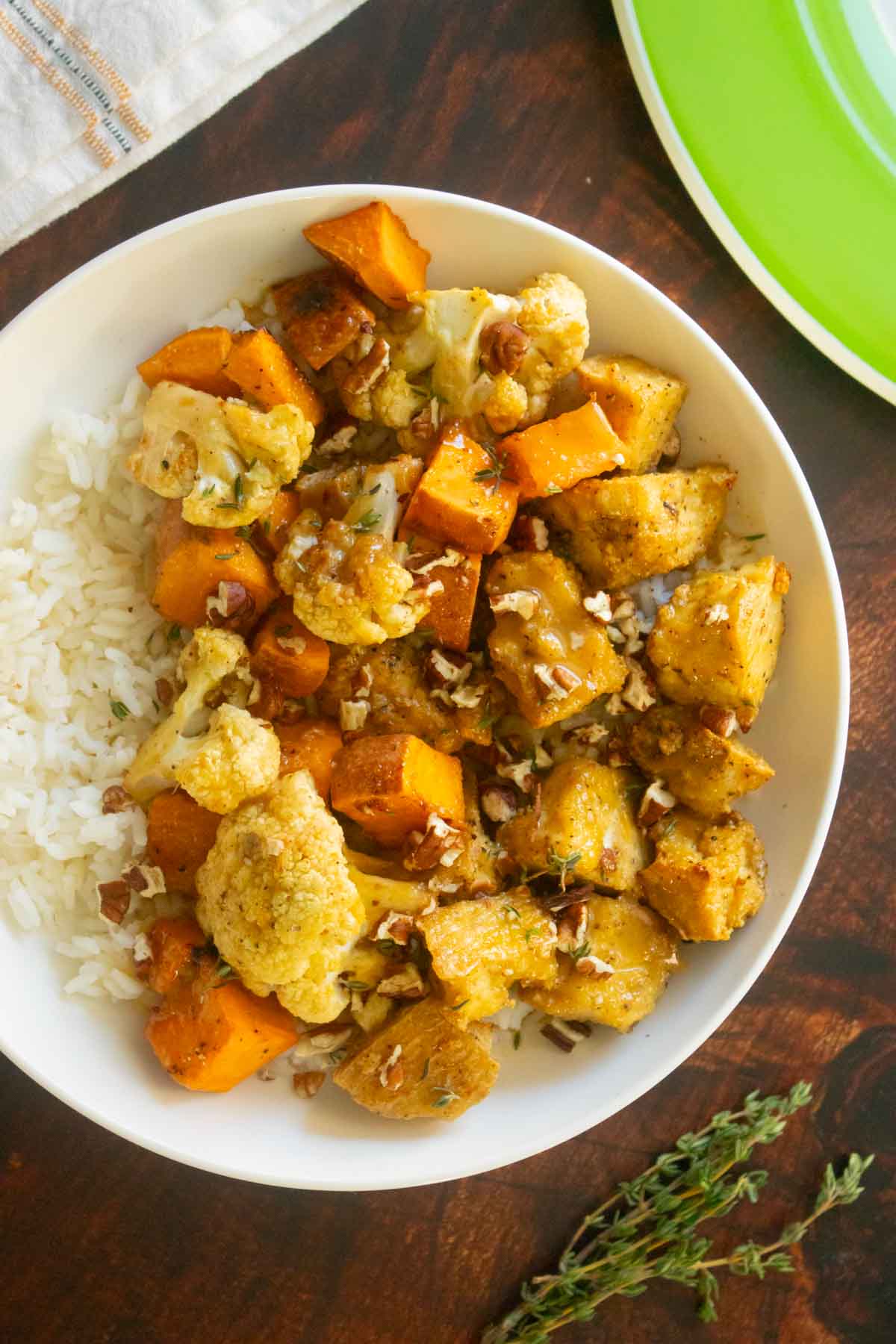plates of the fall sheet pan tofu dinner on a wooden table