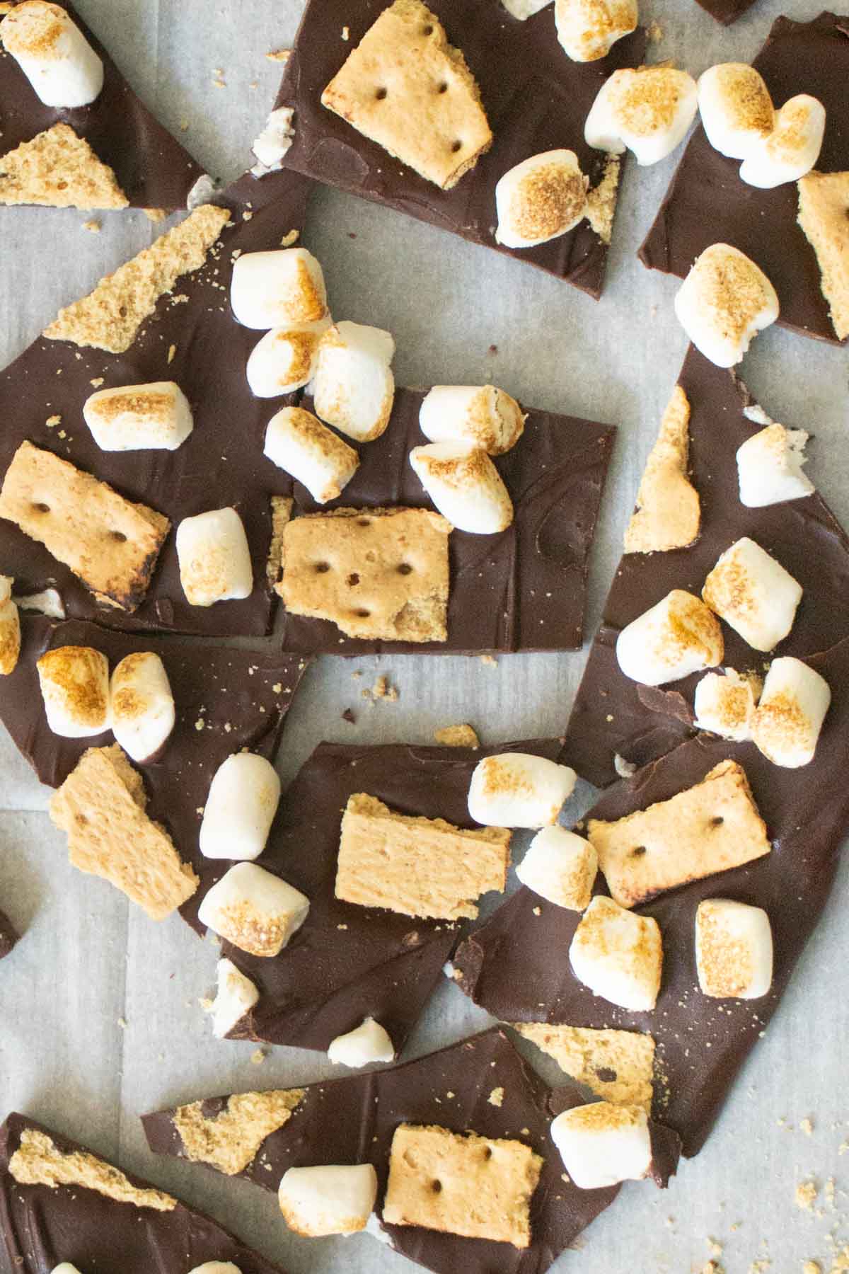 close-up of s'mores bark on the baking sheet after breaking it into pieces