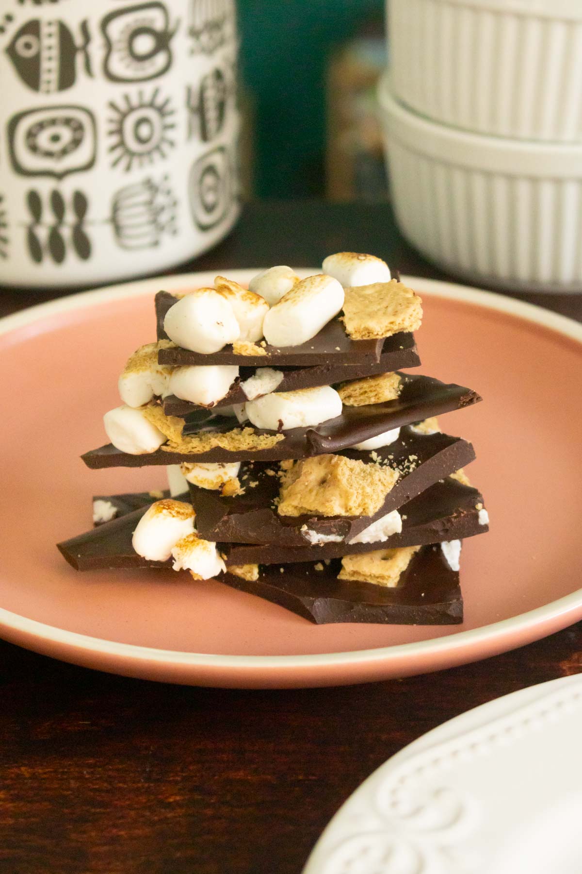 stack of s'mores bark on a pink plate